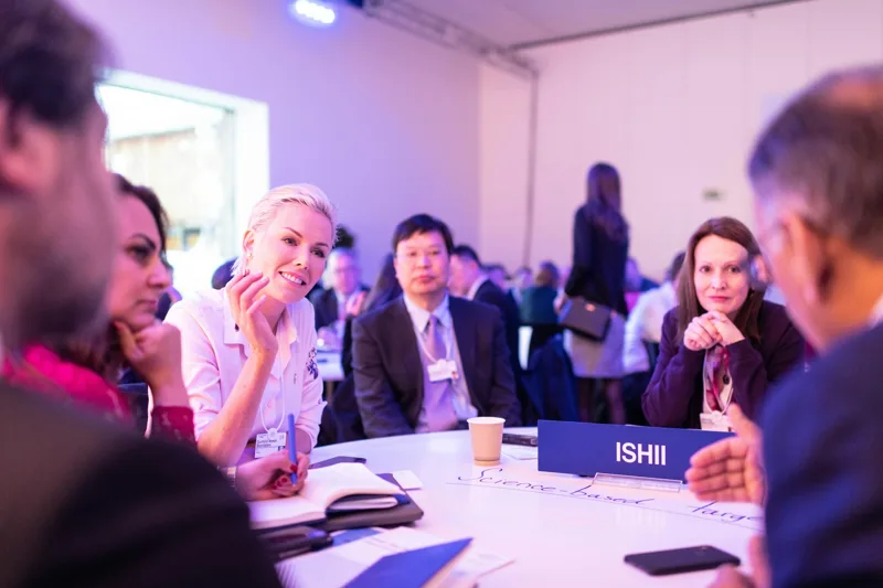Conference participants talking around a table