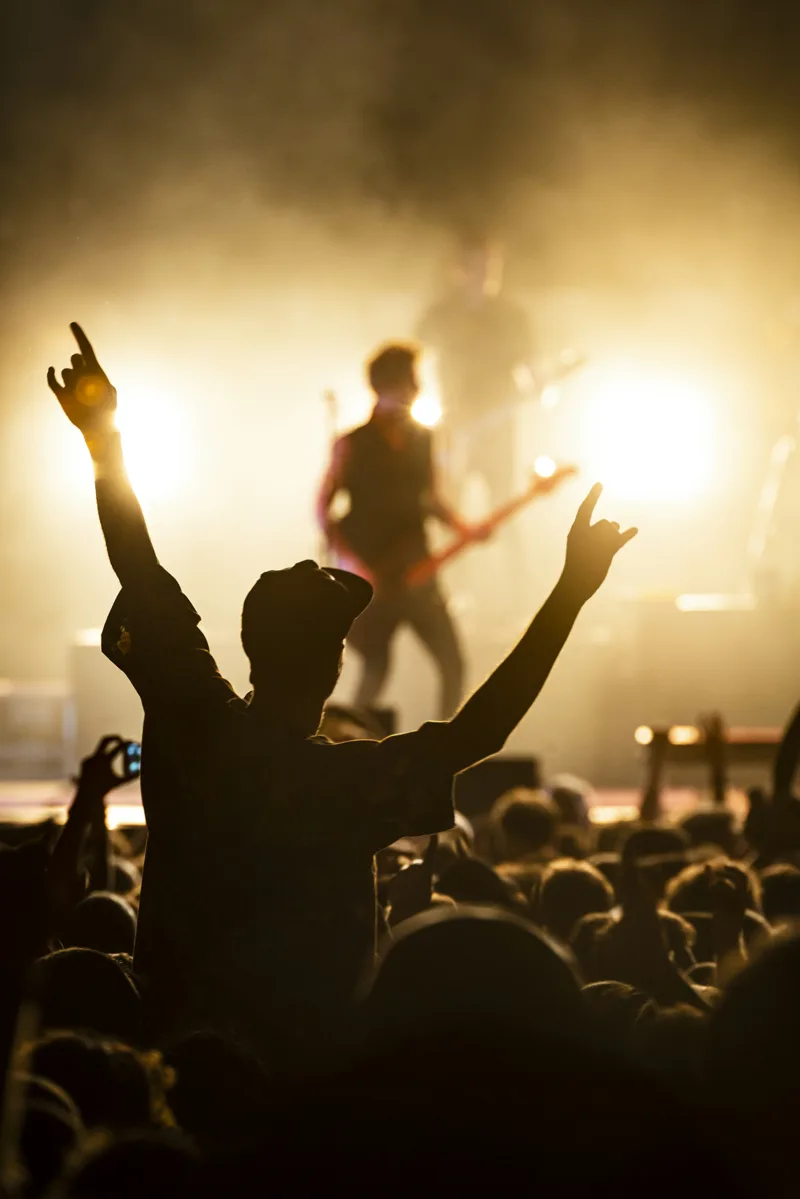 Concert audience beneath warm stage lights