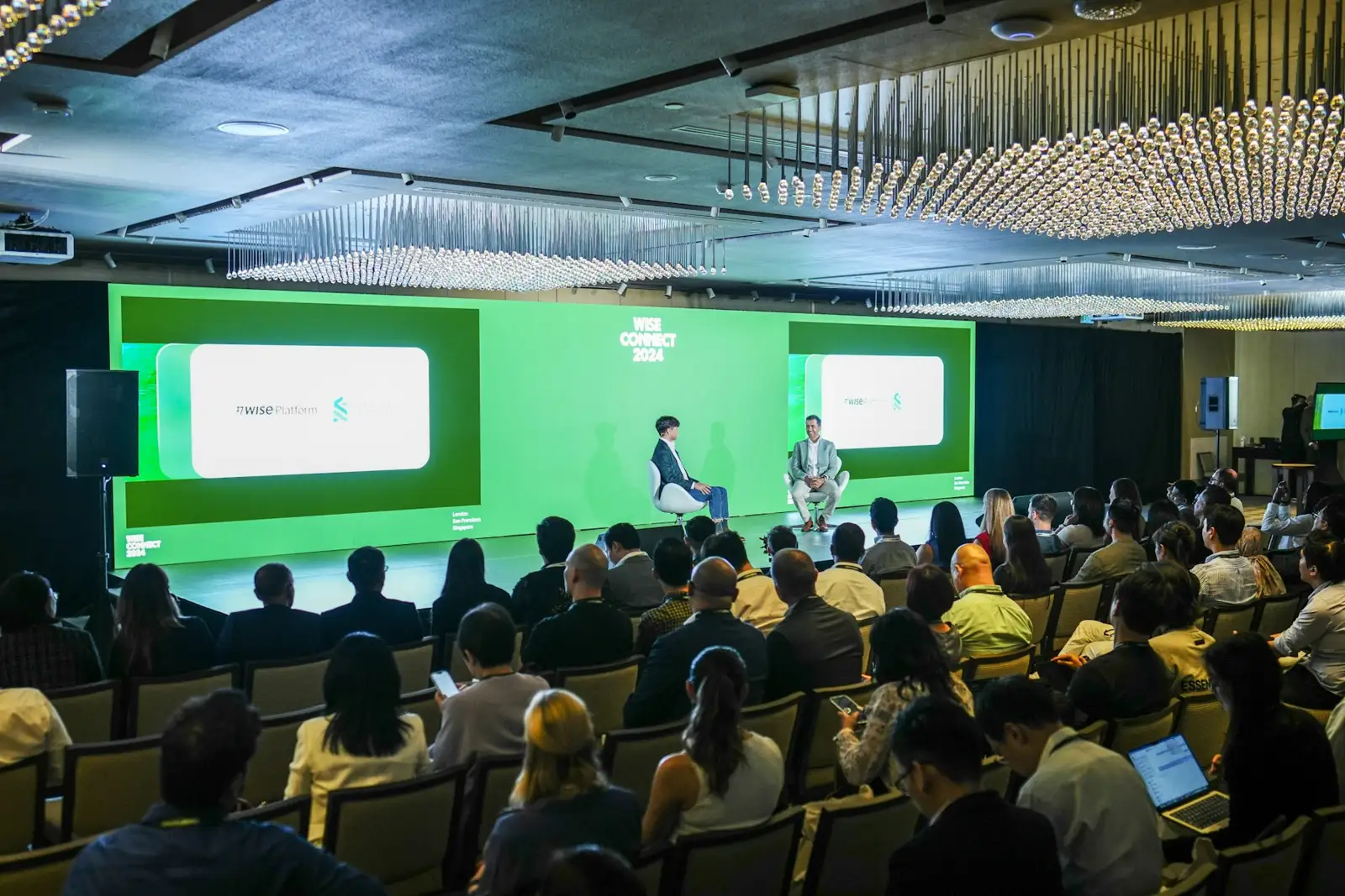 A panel discussion is taking place in front of an audience