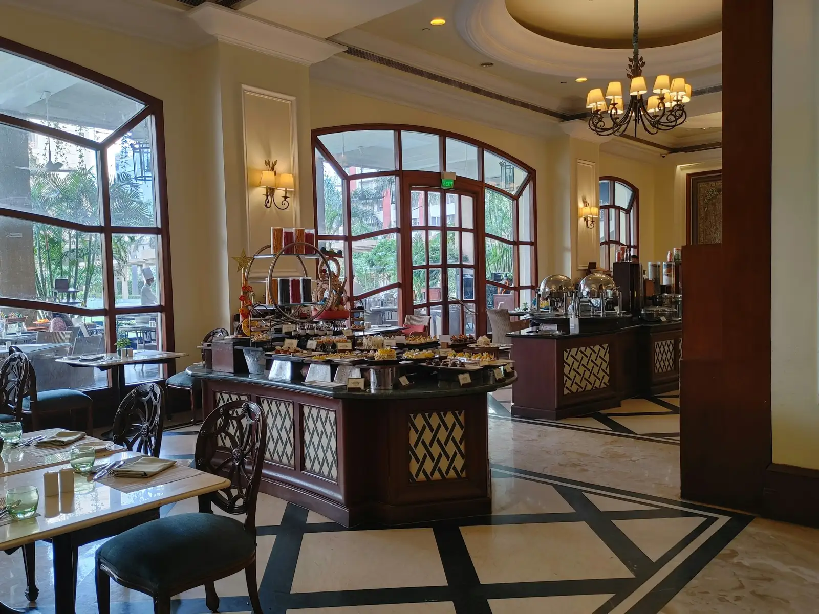 An elegant restaurant with buffet tables and large windows
