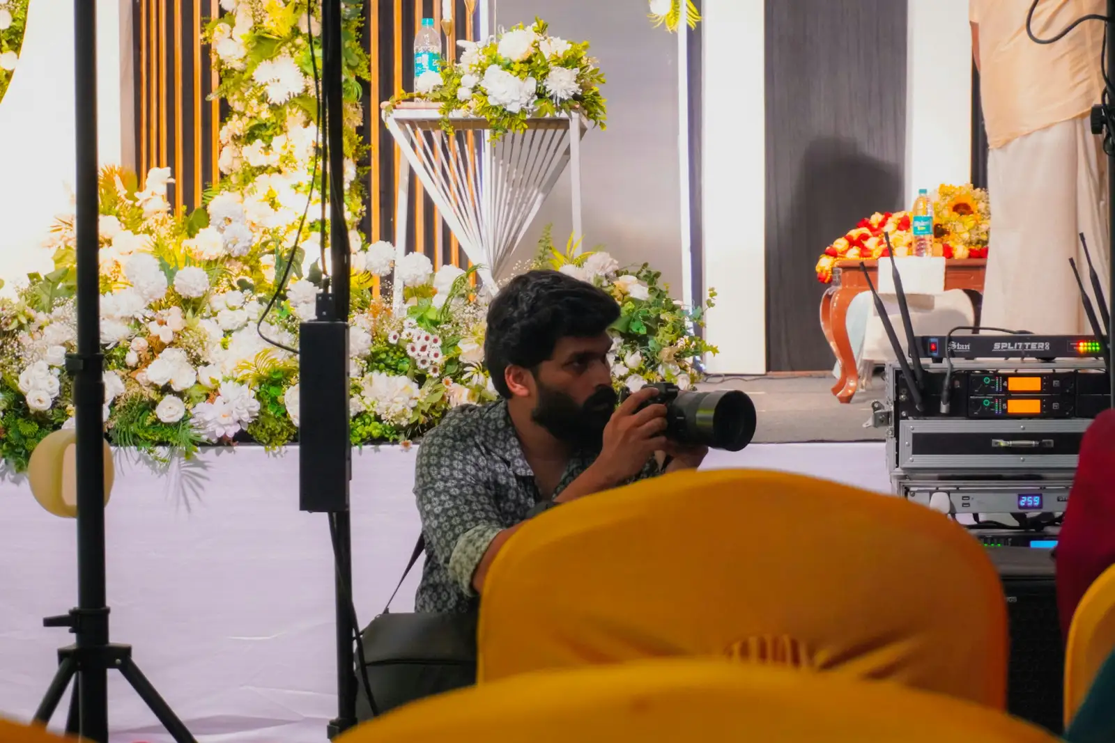 Man with camera photographing event decorations