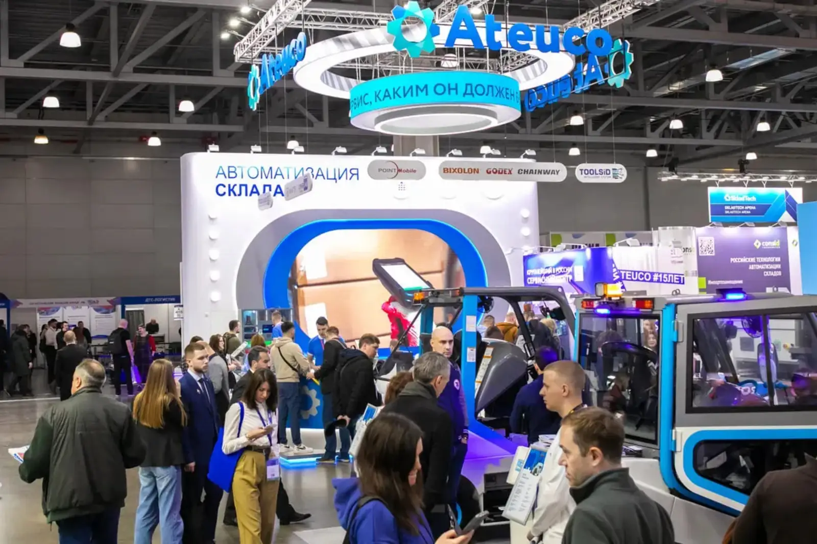 Crowd at an exhibition with booths and displays