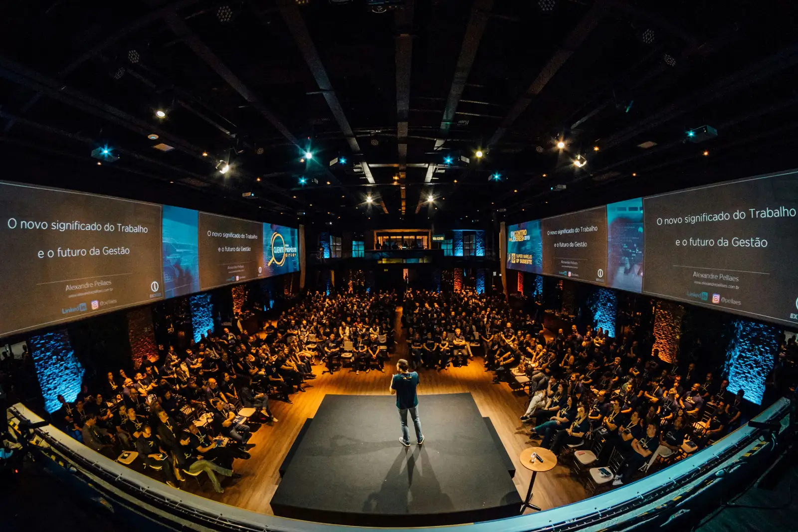 Speaker addressing a full conference auditorium