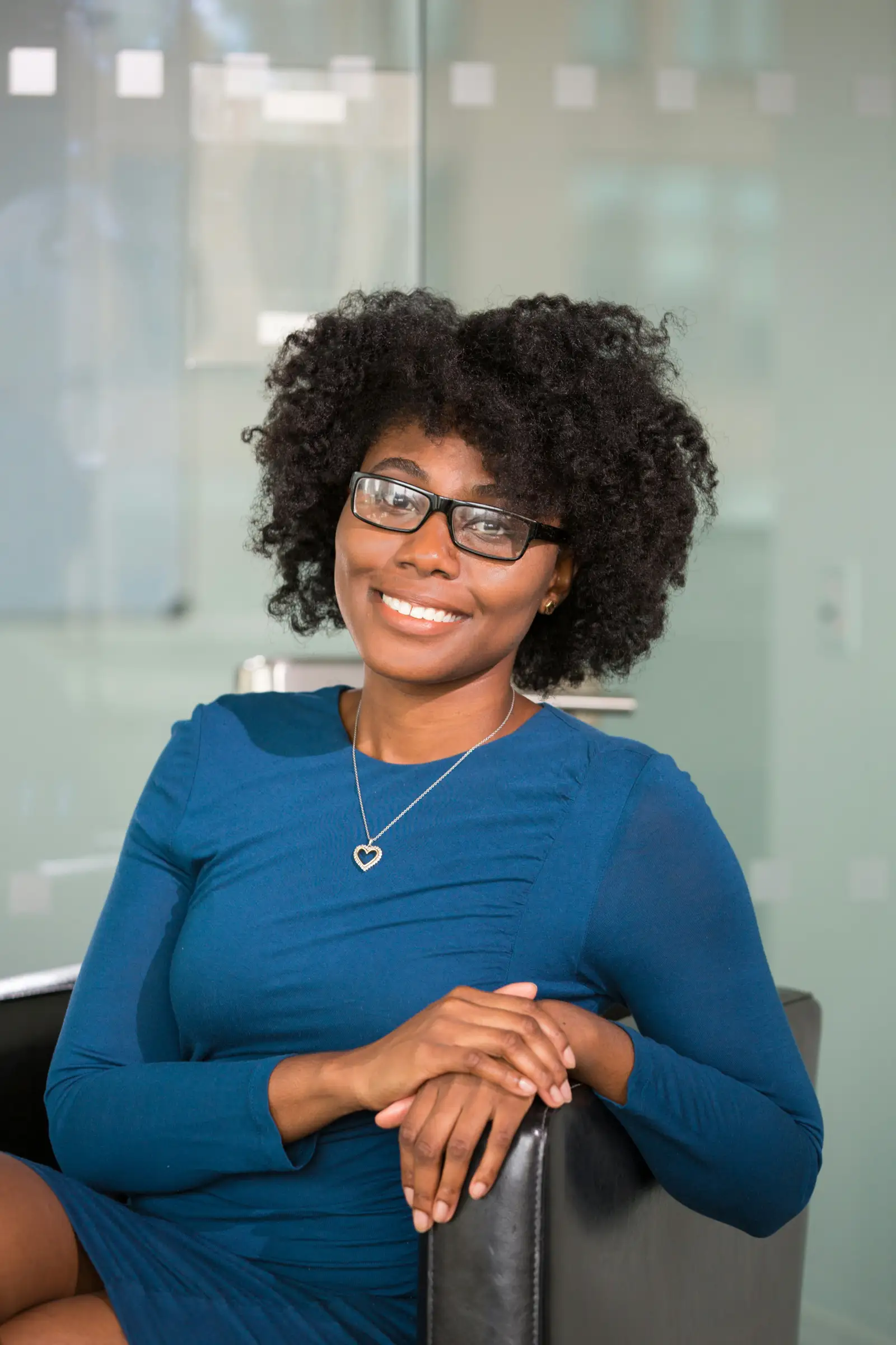 Professional portrait of a smiling woman in a blue dress