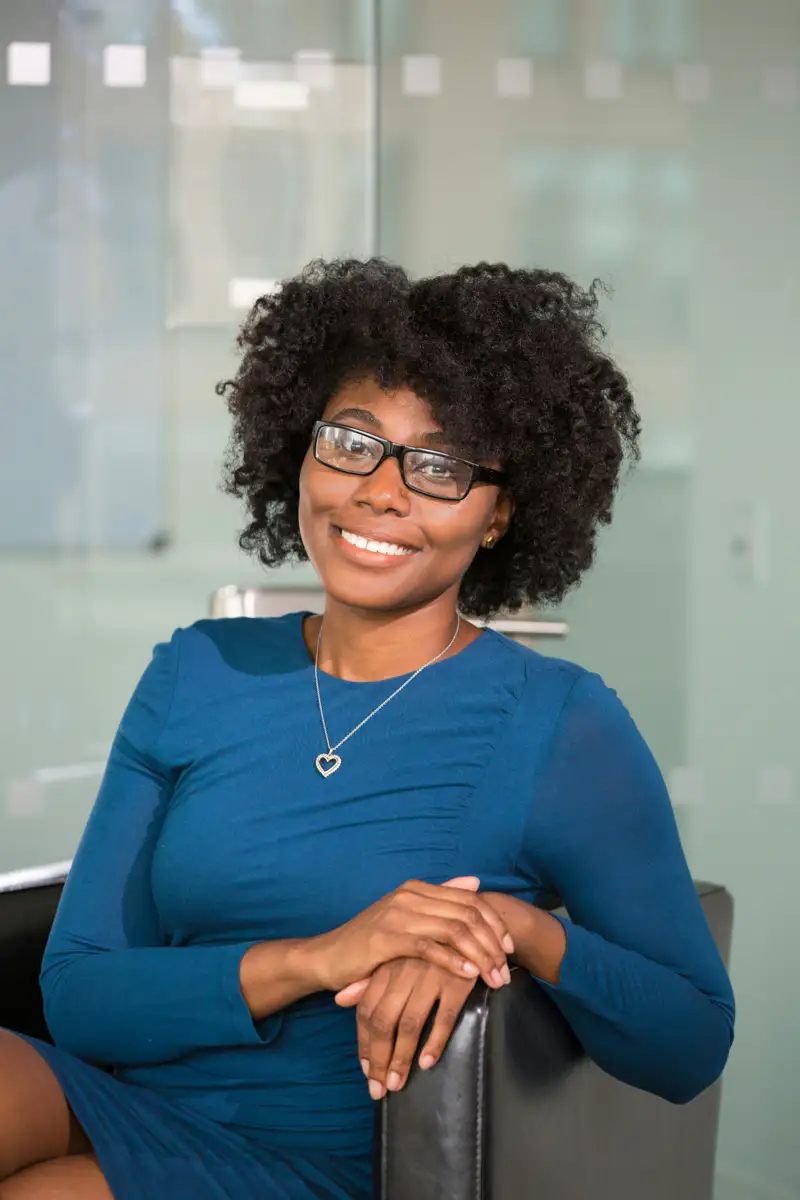 Professional portrait of a smiling woman in a blue dress