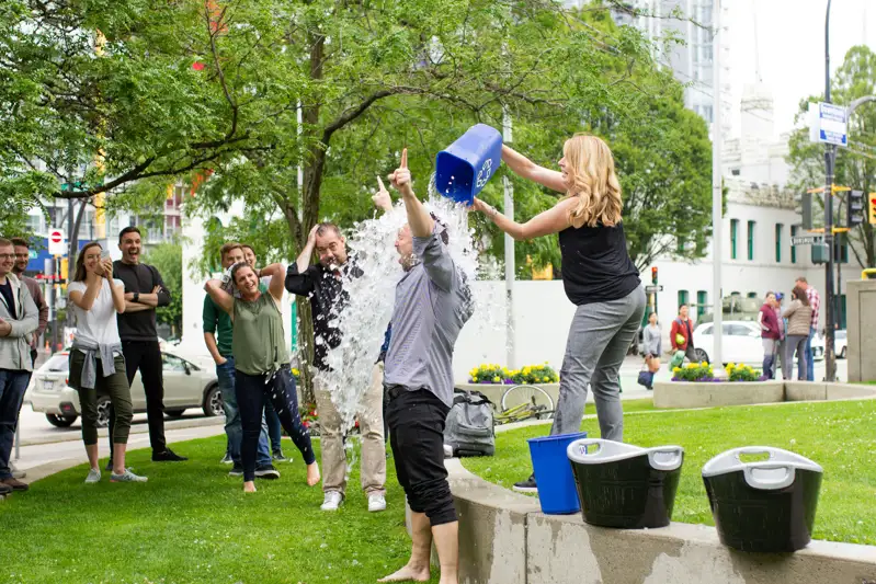 Participants taking part in an outdoor ice bucket fundraising event