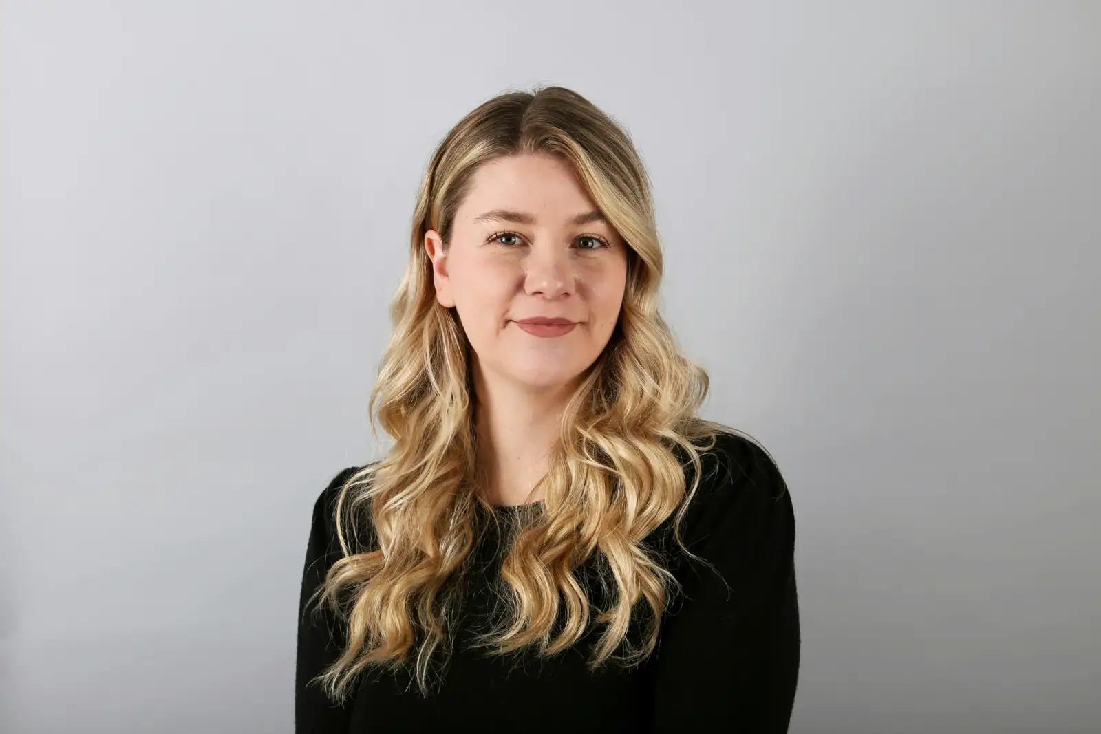 Professional headshot of a woman against a neutral background