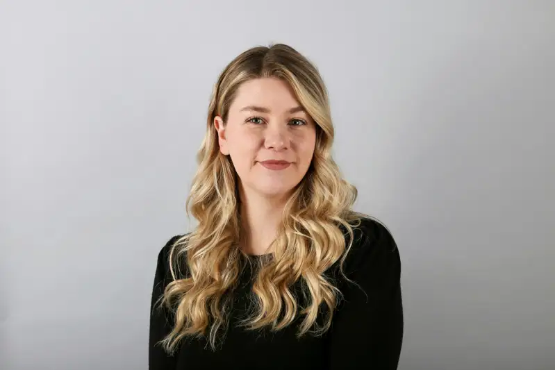 Professional headshot of a woman against a neutral background