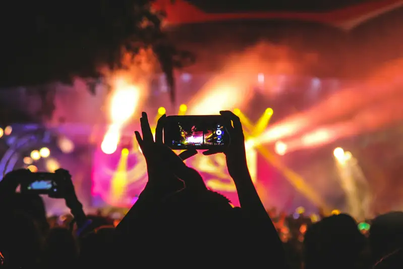 Audience member capturing a concert with a smartphone
