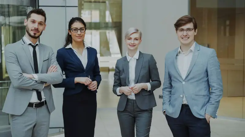 Business team posing together in a bright office