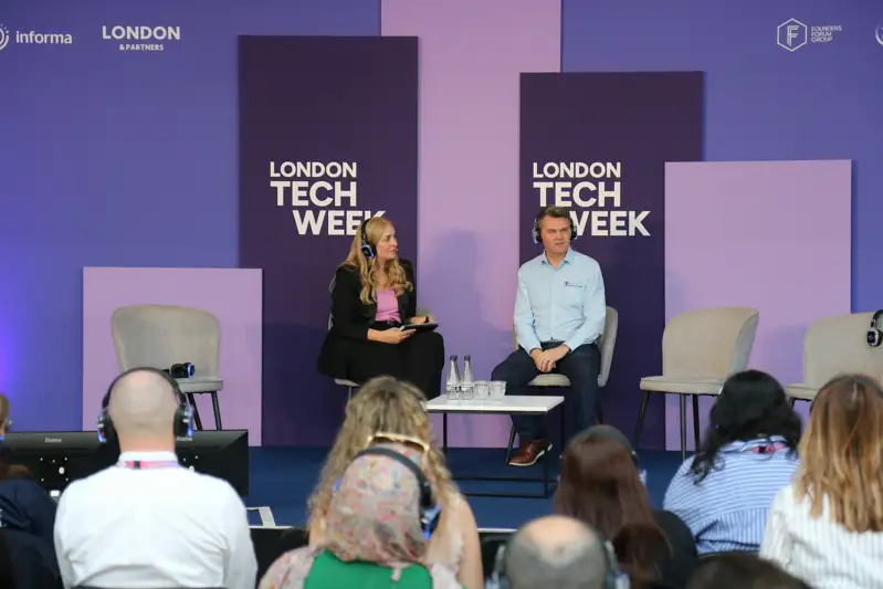 Two speakers on stage at london tech week event