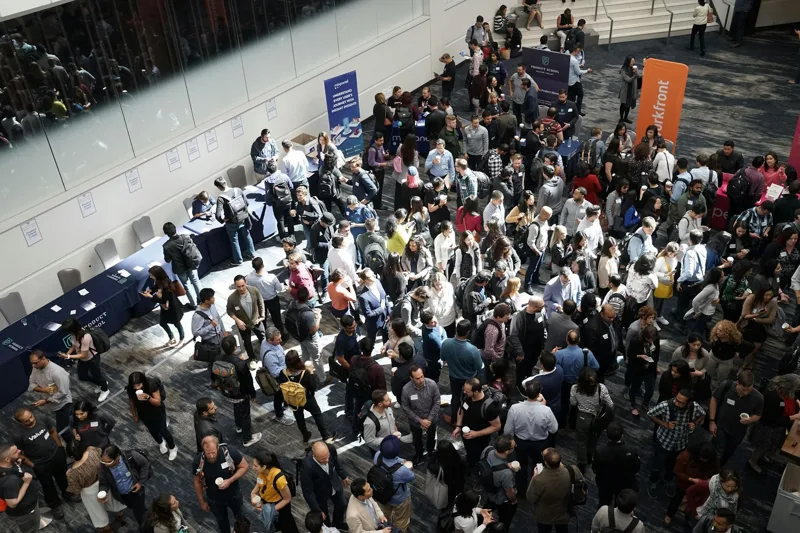 Visitors networking in a bright exhibition hall